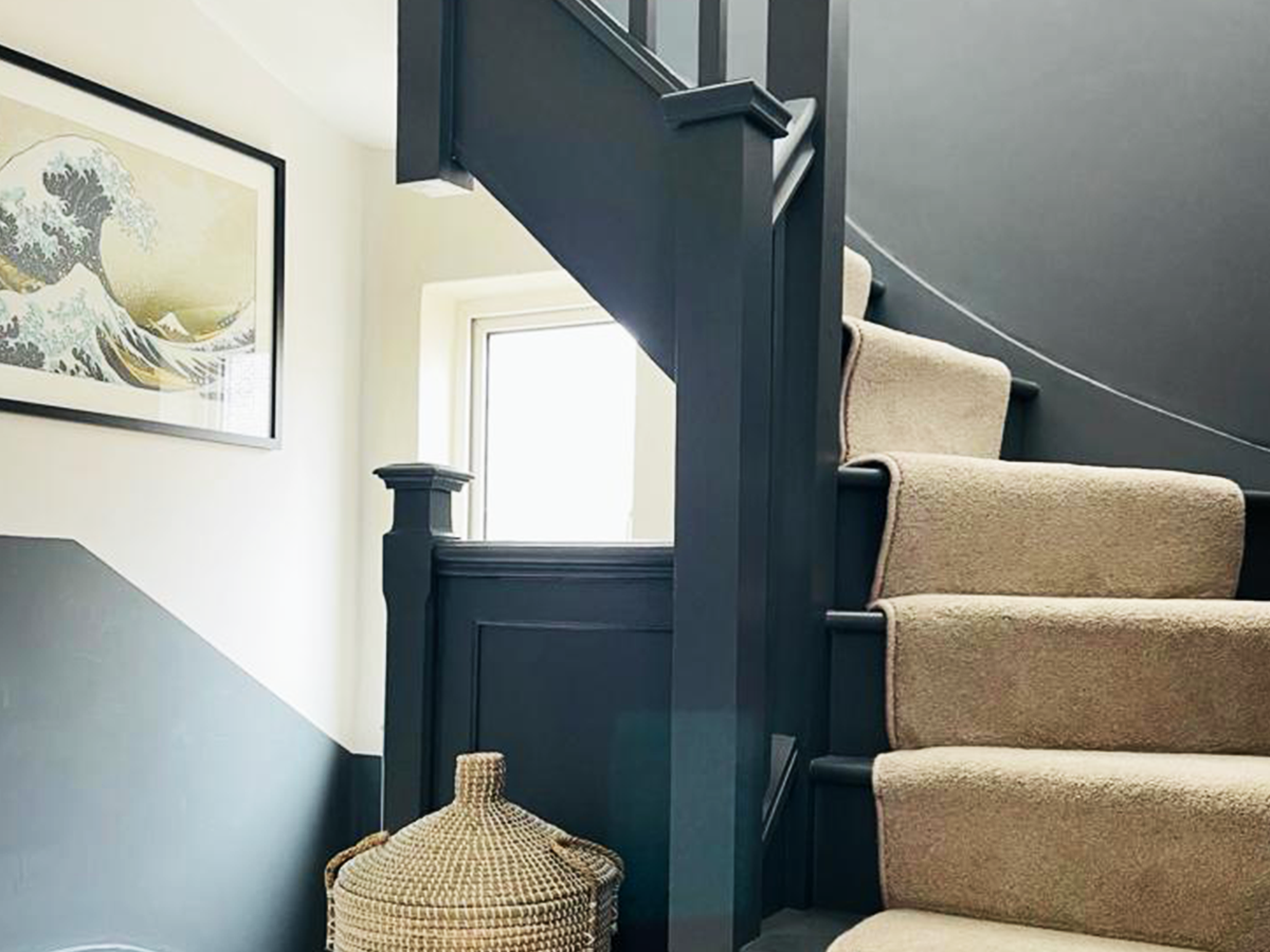 Stairway shot featuring The Great Wave picture in frame and Reside Living beaded basket
