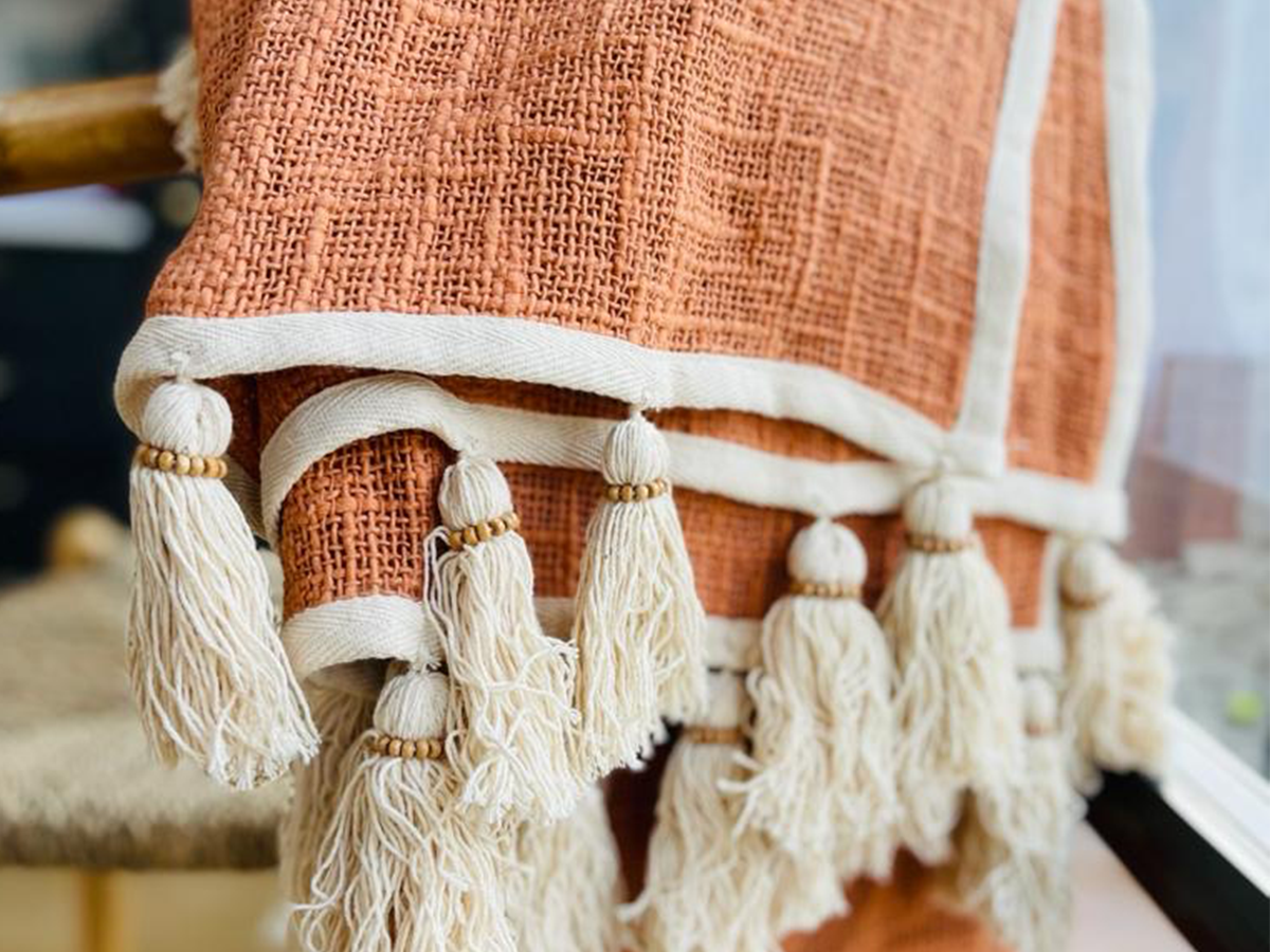Close up of cosy Reside Living woven coral orange PAIGE blanket 